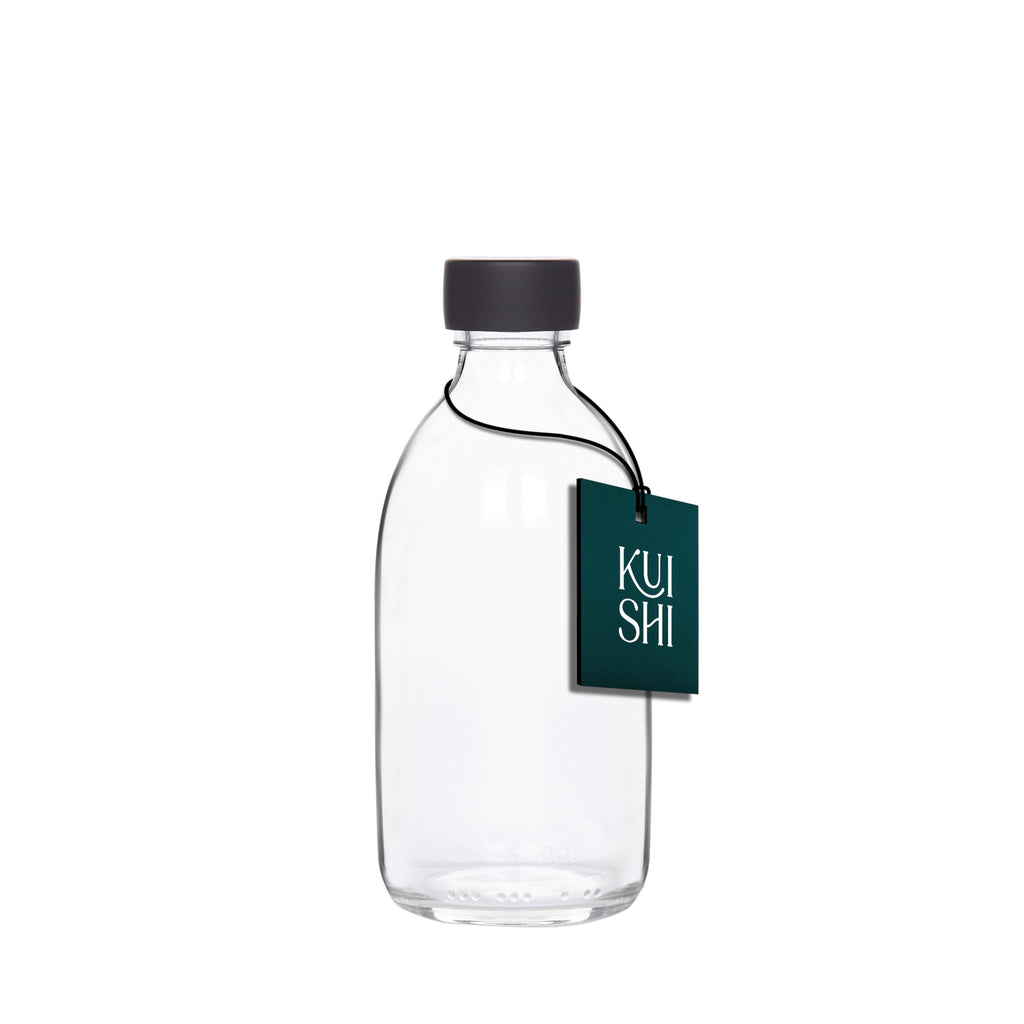 Clear glass storage bottle with a silver stainless steel screw cap for household organization