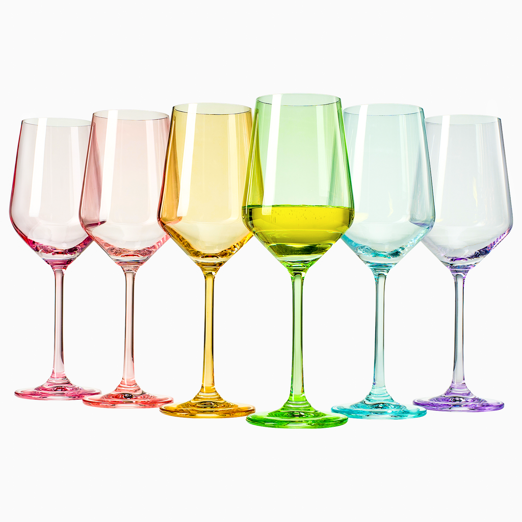 Set of six vibrant colored hand blown crystal wine glasses arranged for an elegant dinner setting