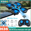 Compact JJRC H36 mini drone with remote controller and spare propeller blades on solid background