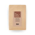 Bag of fresh Costa Rica Tarrazu whole coffee beans in eco-friendly kraft paper packaging