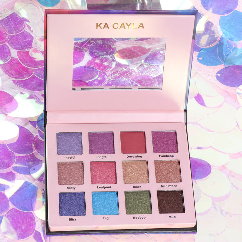 Open 12-color eyeshadow palette in a compact black case showing vibrant and neutral shades