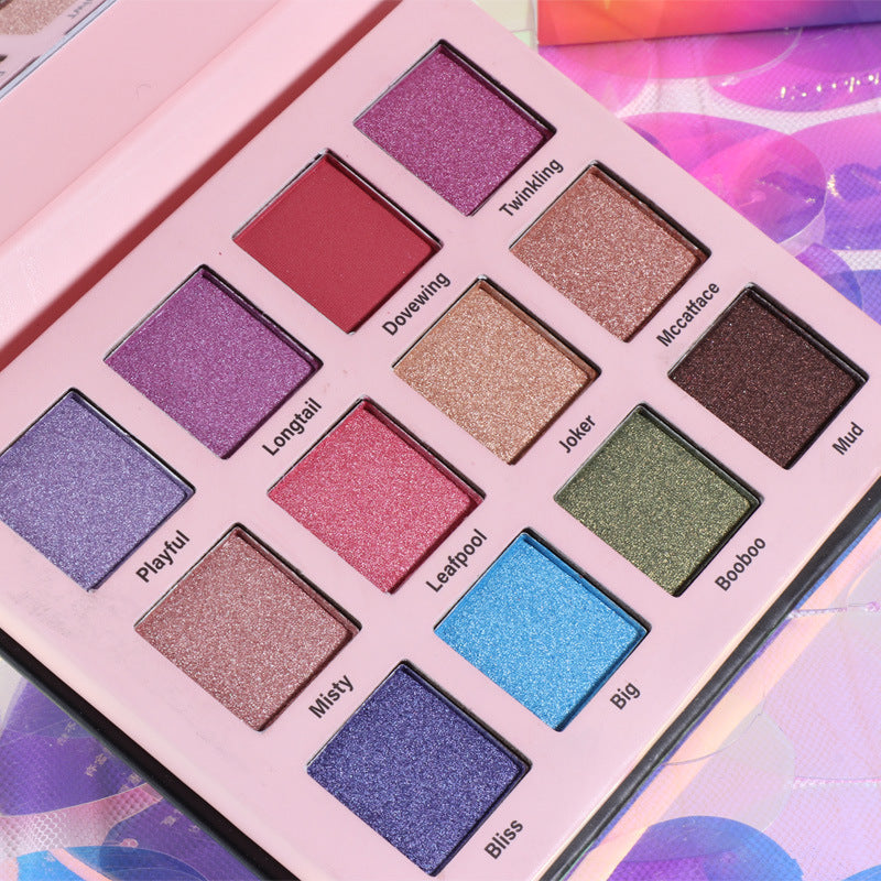 Open 12-color eyeshadow palette in a compact black case showing vibrant and neutral shades — view 5