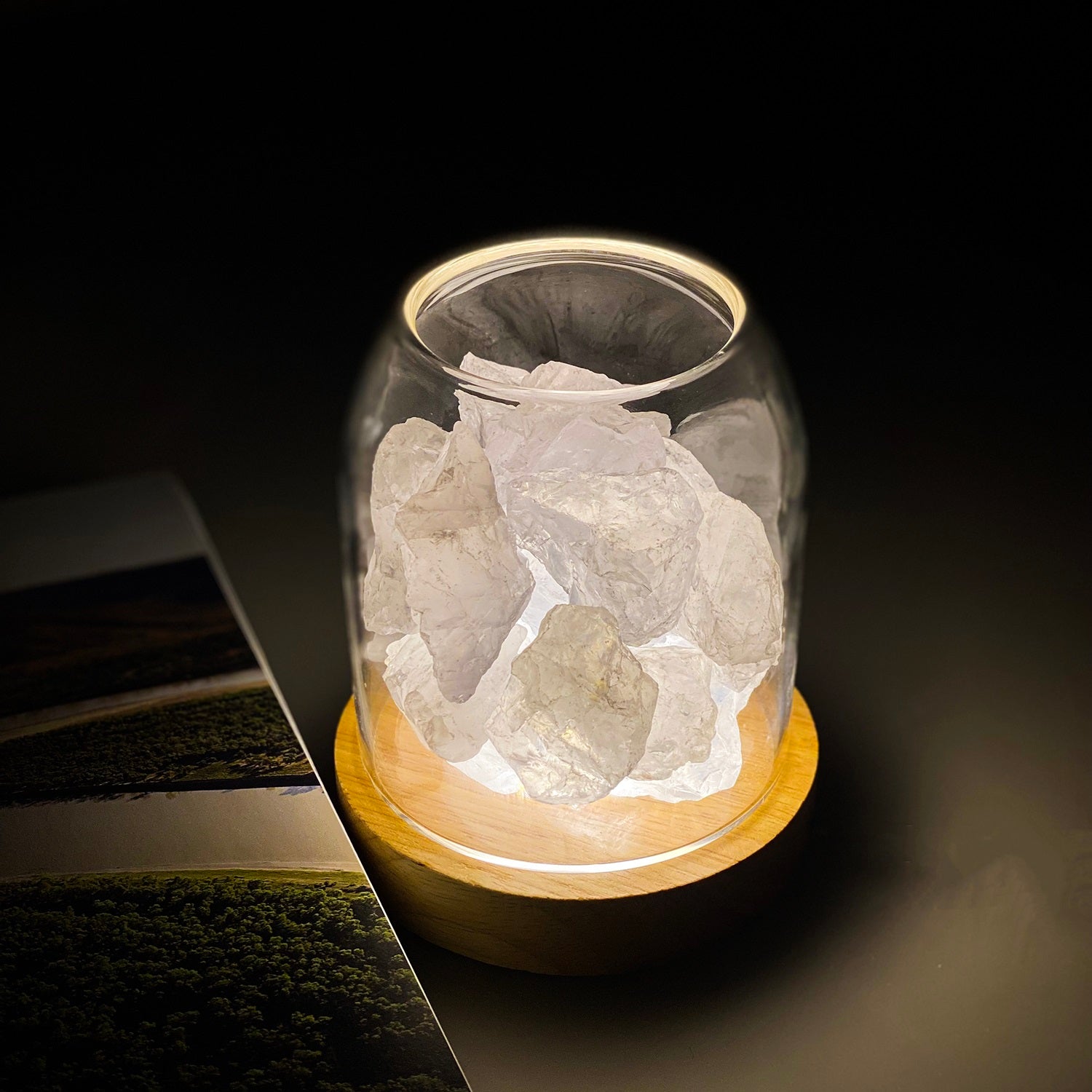AURORA natural quartz crystal essential oil diffuser with wooden base and glass reservoir illuminated. — view 3