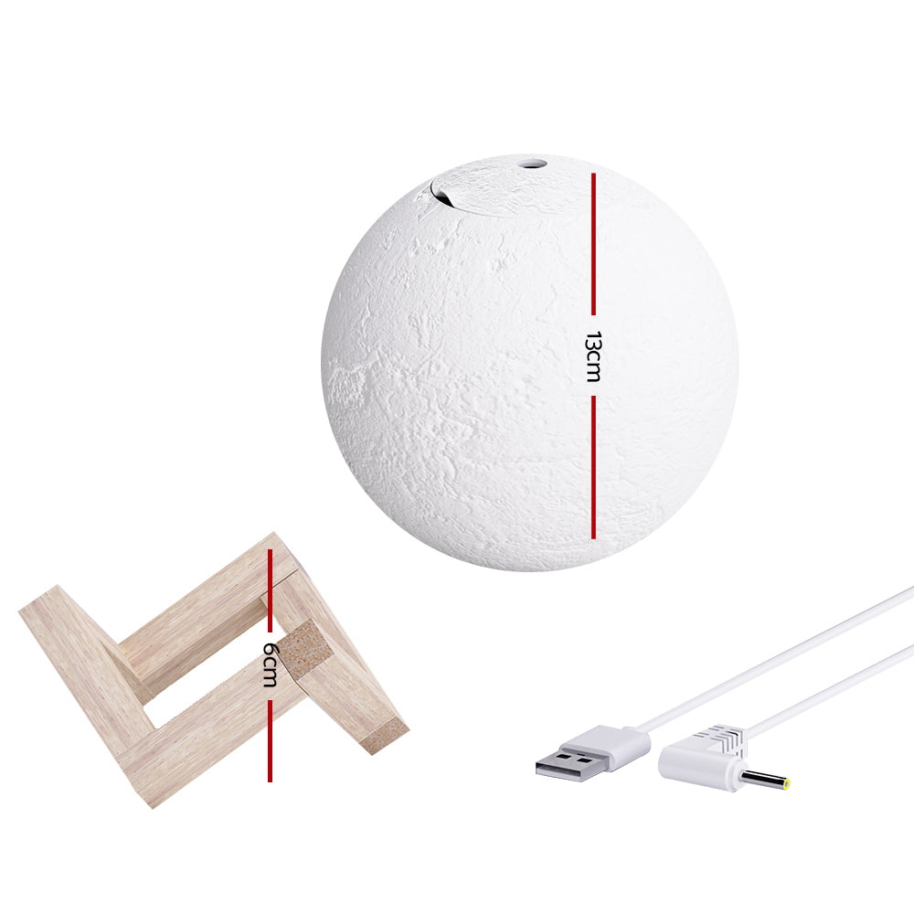 White LED moon lamp aroma diffuser resting on a wooden base with mist emitting from top — view 2