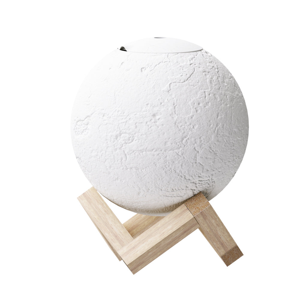 White LED moon lamp aroma diffuser resting on a wooden base with mist emitting from top — view 3