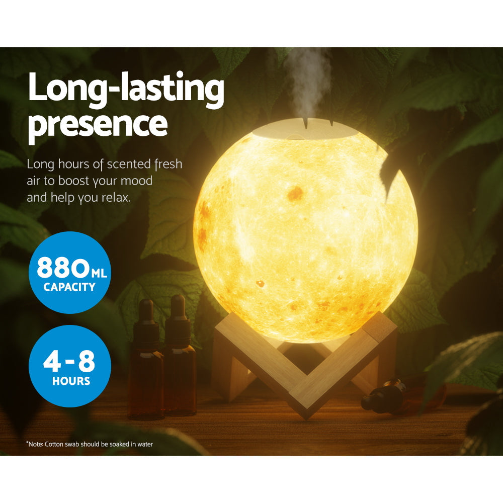 White LED moon lamp aroma diffuser resting on a wooden base with mist emitting from top — view 5