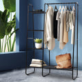 Black metal freestanding clothes rack with a hanging bar and five fabric storage shelves.