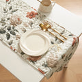 Reversible floral quilted table runner in beige and soft green for dining room tabletop protection