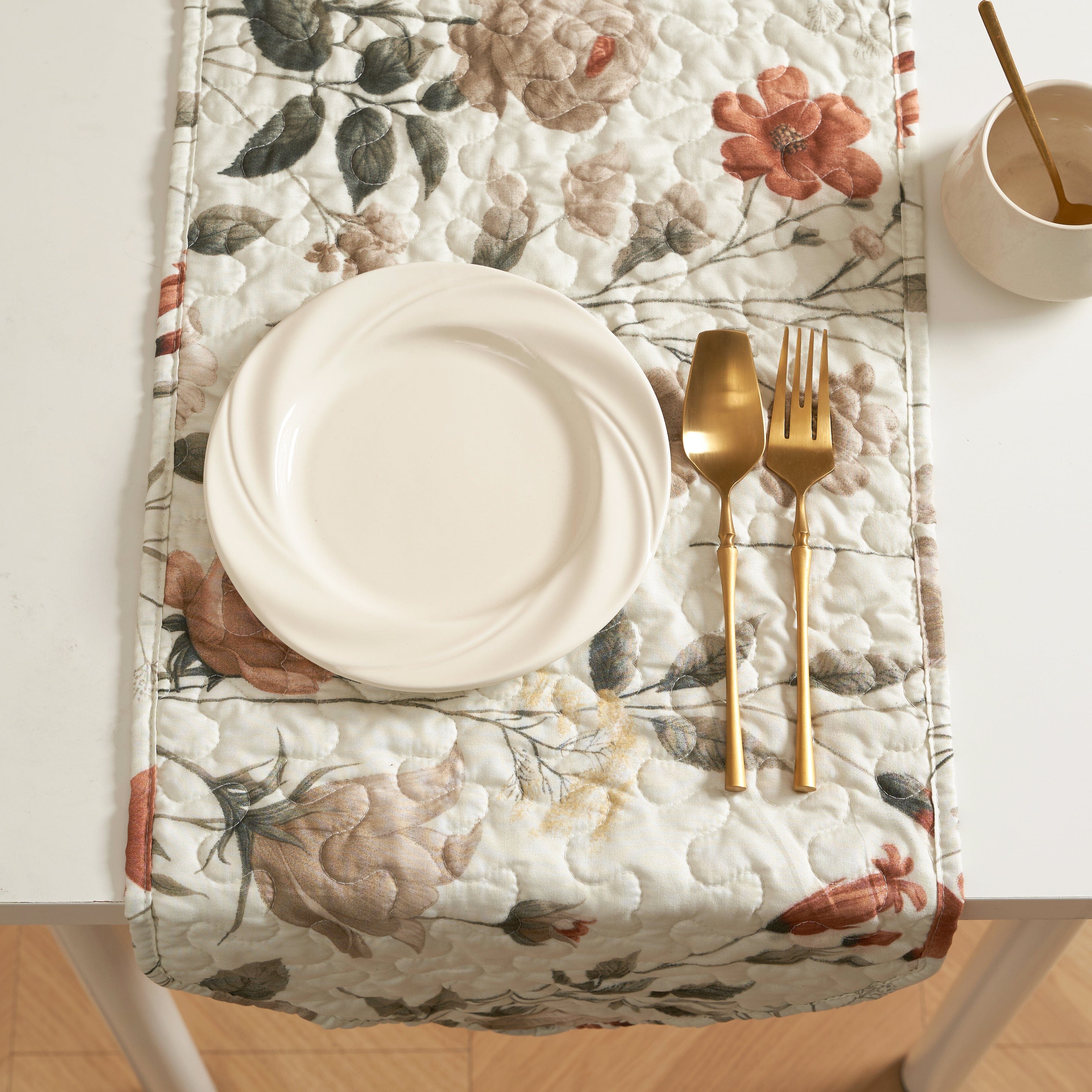 Reversible floral quilted table runner in beige and soft green for dining room tabletop protection — view 4