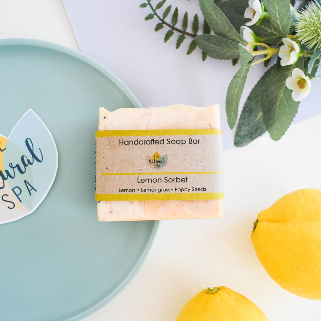 Lemon sorbet handmade natural soap bar with poppy seeds, showcasing a textured yellow botanical finish.