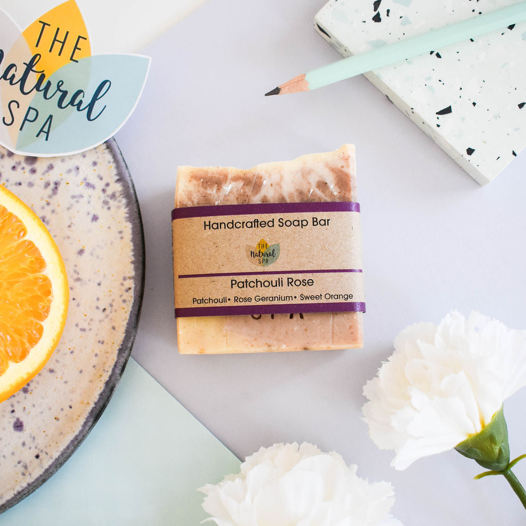 Patchouli and rose natural handcrafted vegan soap bar with rustic botanical texture and clay finish
