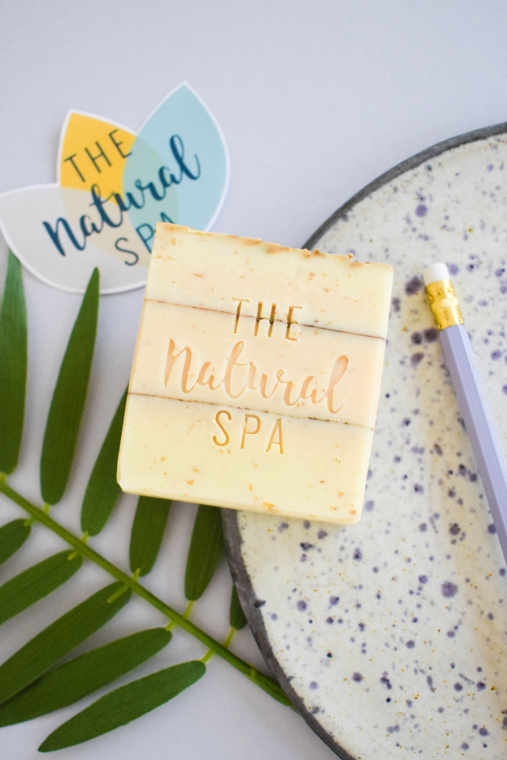 Handmade natural lavender verbena soap bar displayed with botanical ingredients and a rich creamy lather — view 3