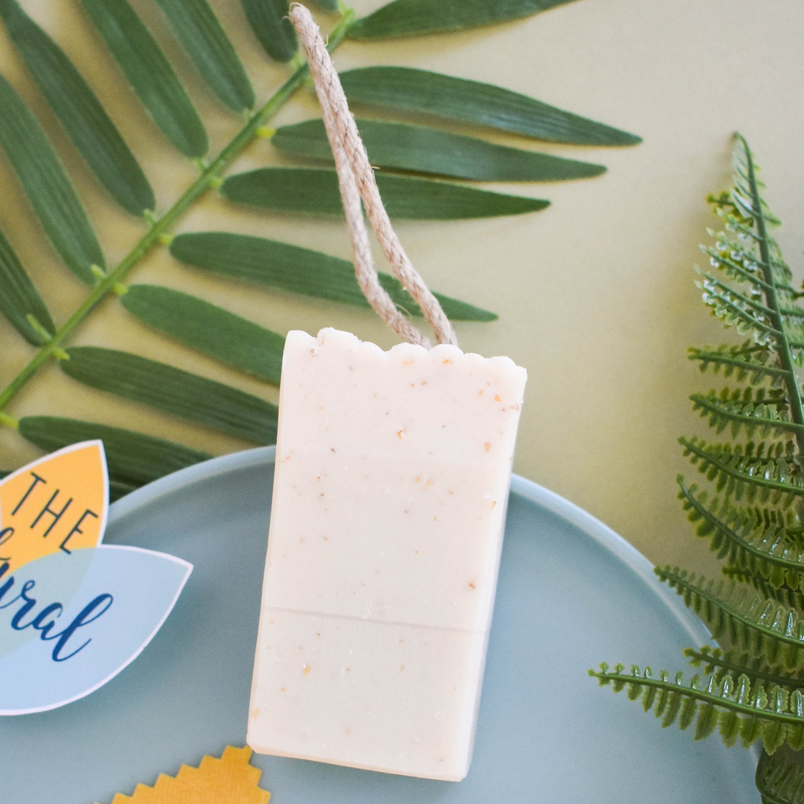Rustic handcrafted herb garden soap on a cotton rope featuring natural exfoliating oats and clay — view 2