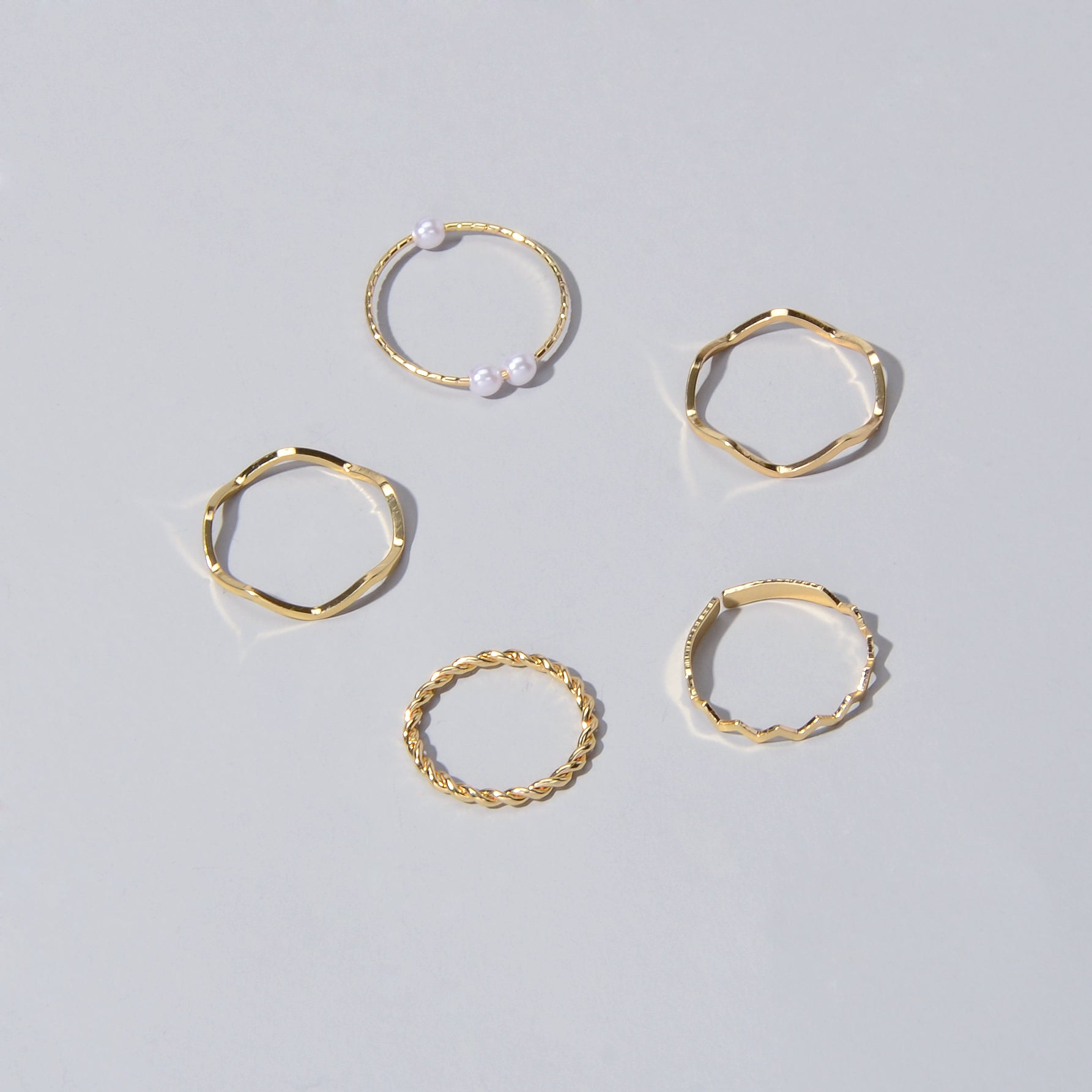 5 piece stackable minimalist finger ring set in metal with elegant pearl accents — view 3