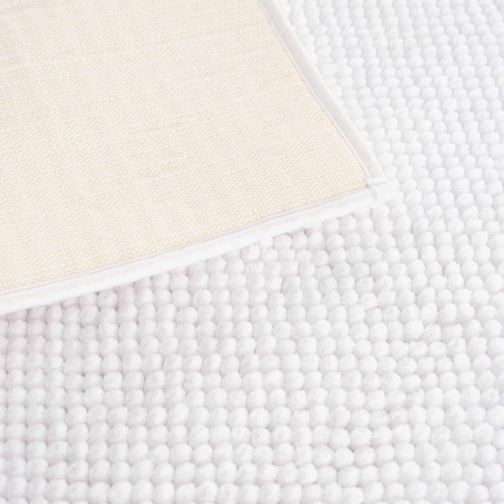 Plush solid white washable bath mat made of thick absorbent polyester for bathroom floors — view 5