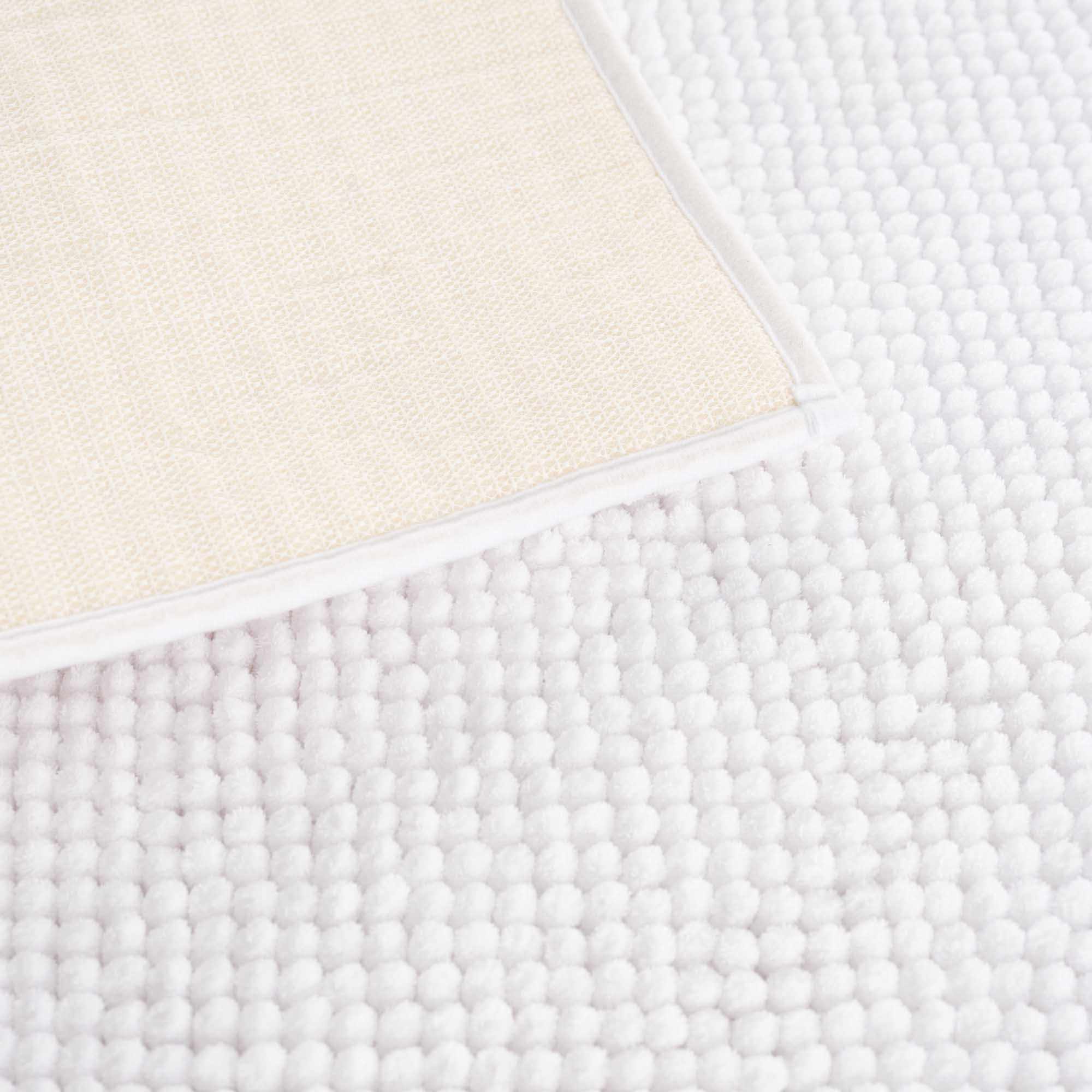 Plush solid white washable bath mat made of thick absorbent polyester for bathroom floors — view 5
