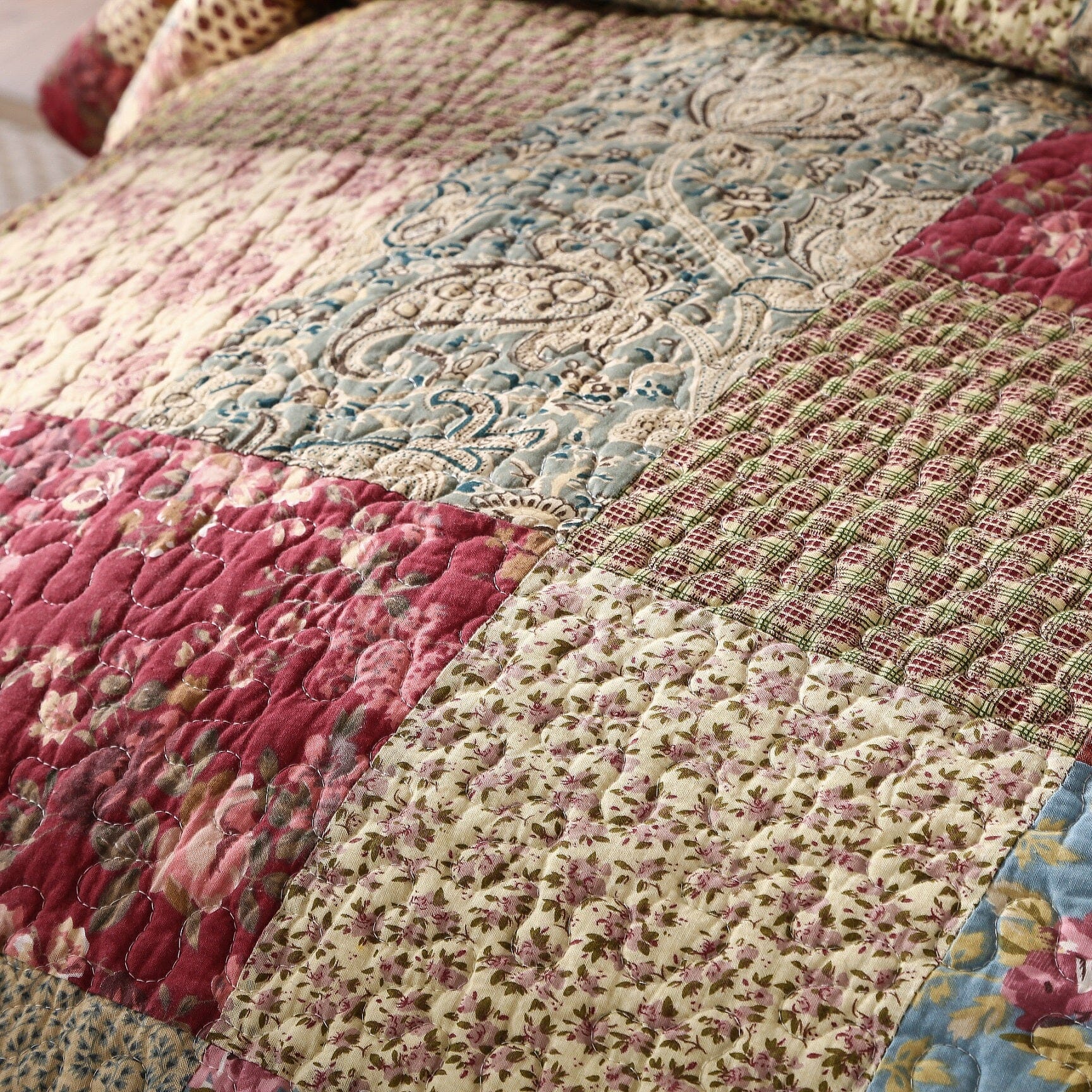 Cotton patchwork quilt set featuring a beige and burgundy floral paisley pattern on a bed — view 4