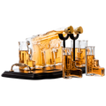 Double pistol whiskey decanter set with six shot glasses on a wooden display stand