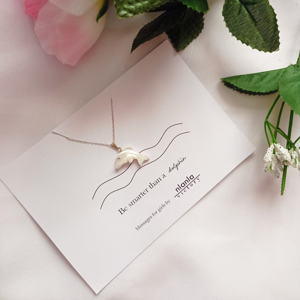 Sterling silver dolphin necklace with mother of pearl charm and an inspiring affirmation message card.