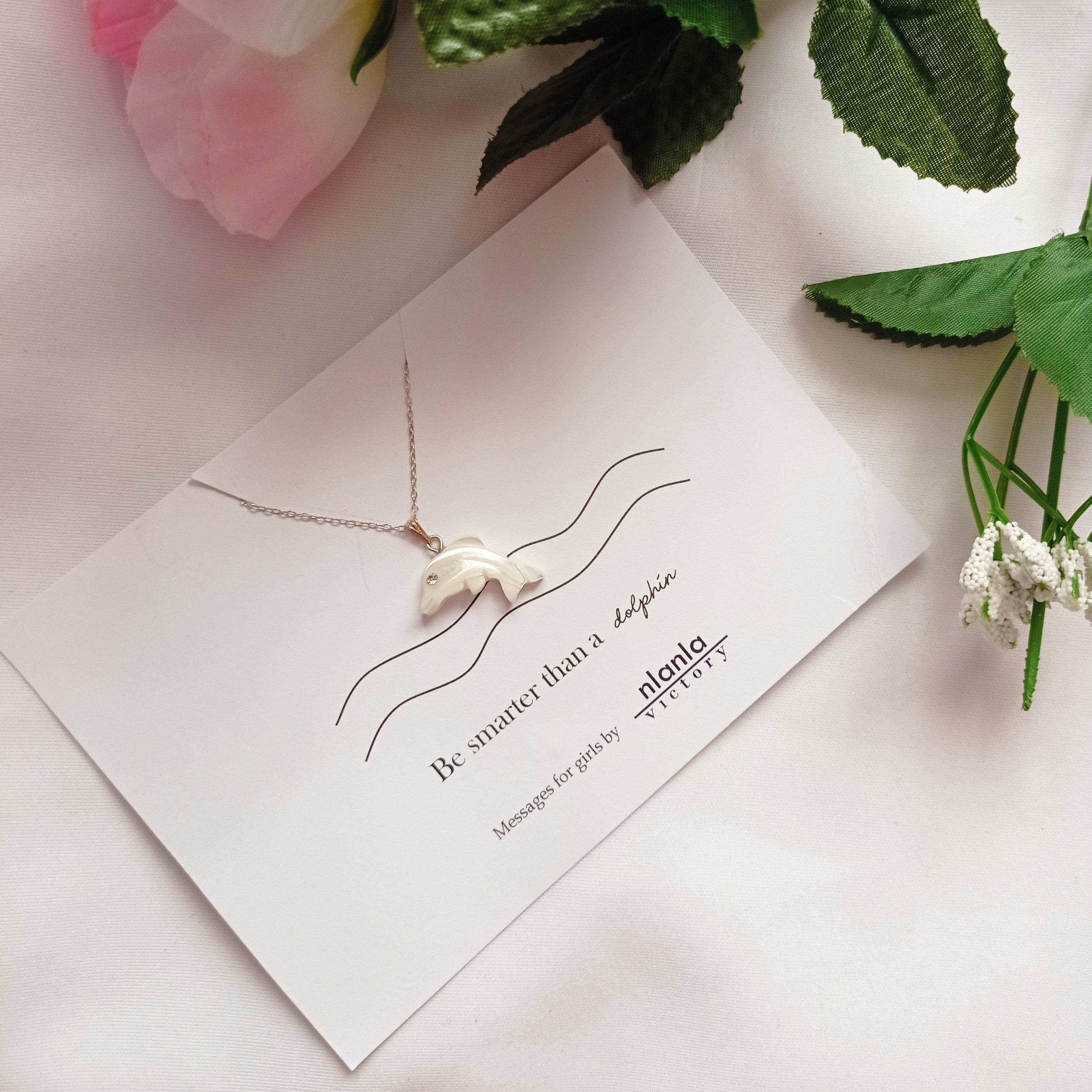 Sterling silver dolphin necklace with mother of pearl charm and an inspiring affirmation message card.