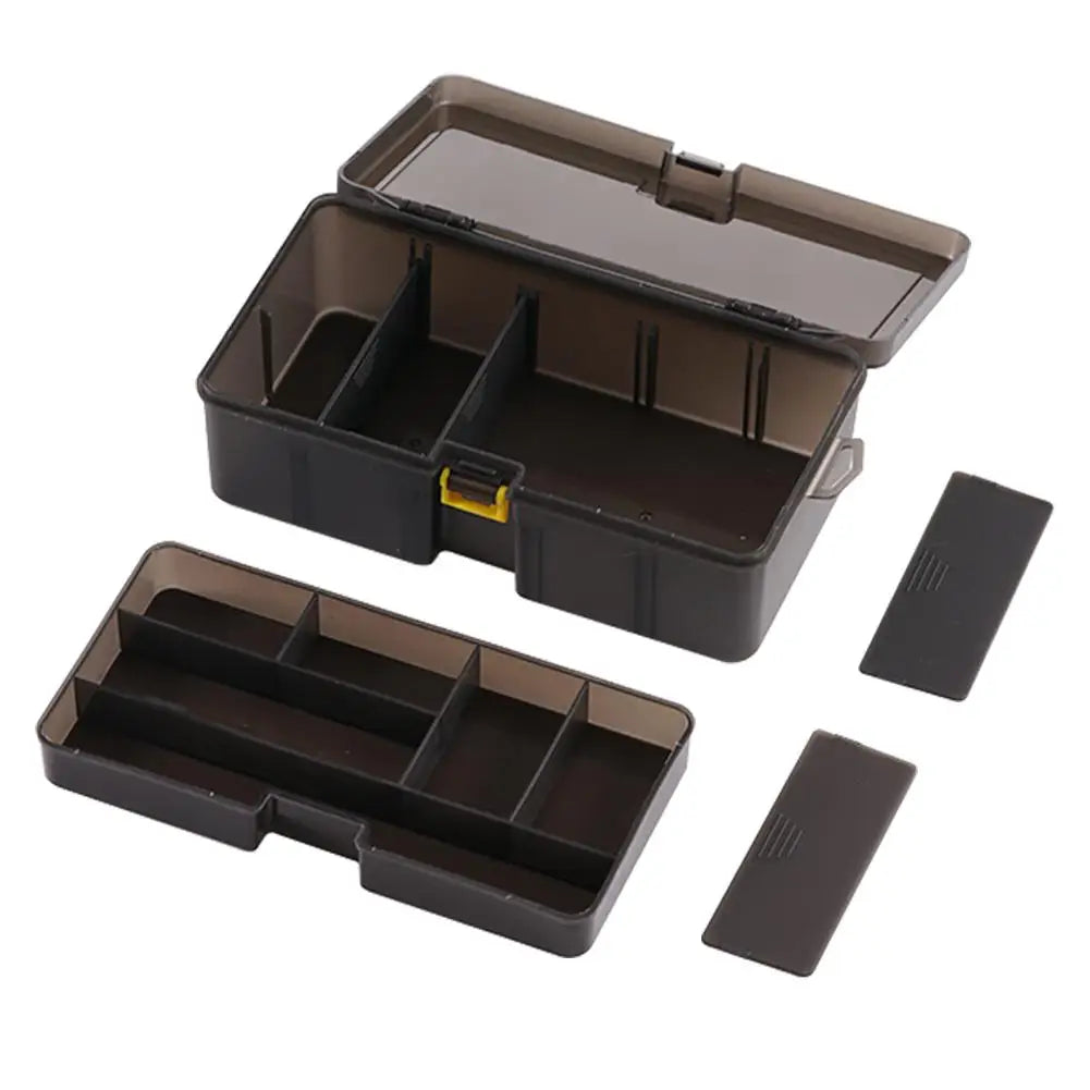 Double layer fishing tackle box in durable resin with adjustable compartments for bait and hooks.