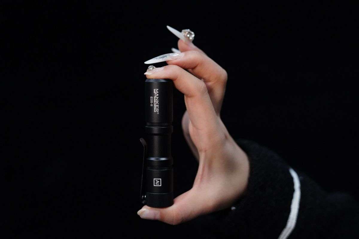 Compact black tactical EDC flashlight with stainless steel deep carry pocket clip. — view 2