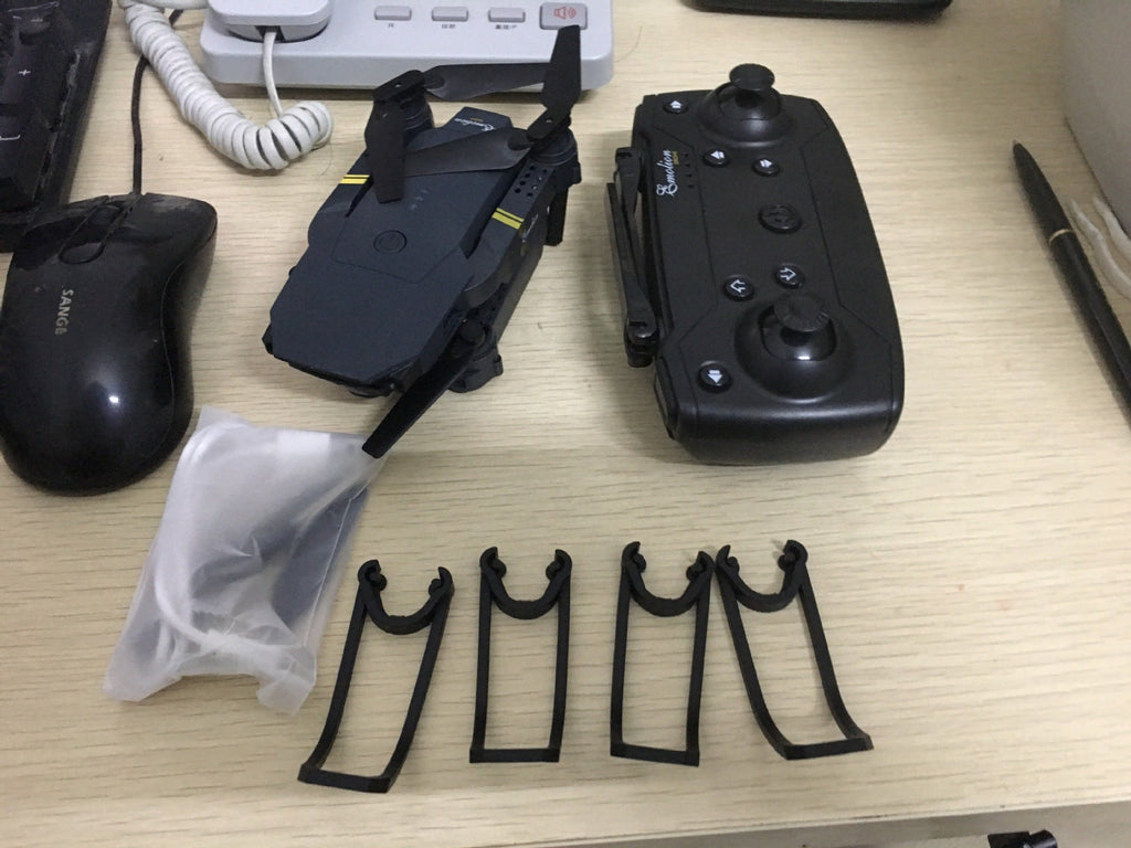 Black foldable WiFi FPV drone with carbon fiber frame, fan blades, and remote controller — view 4