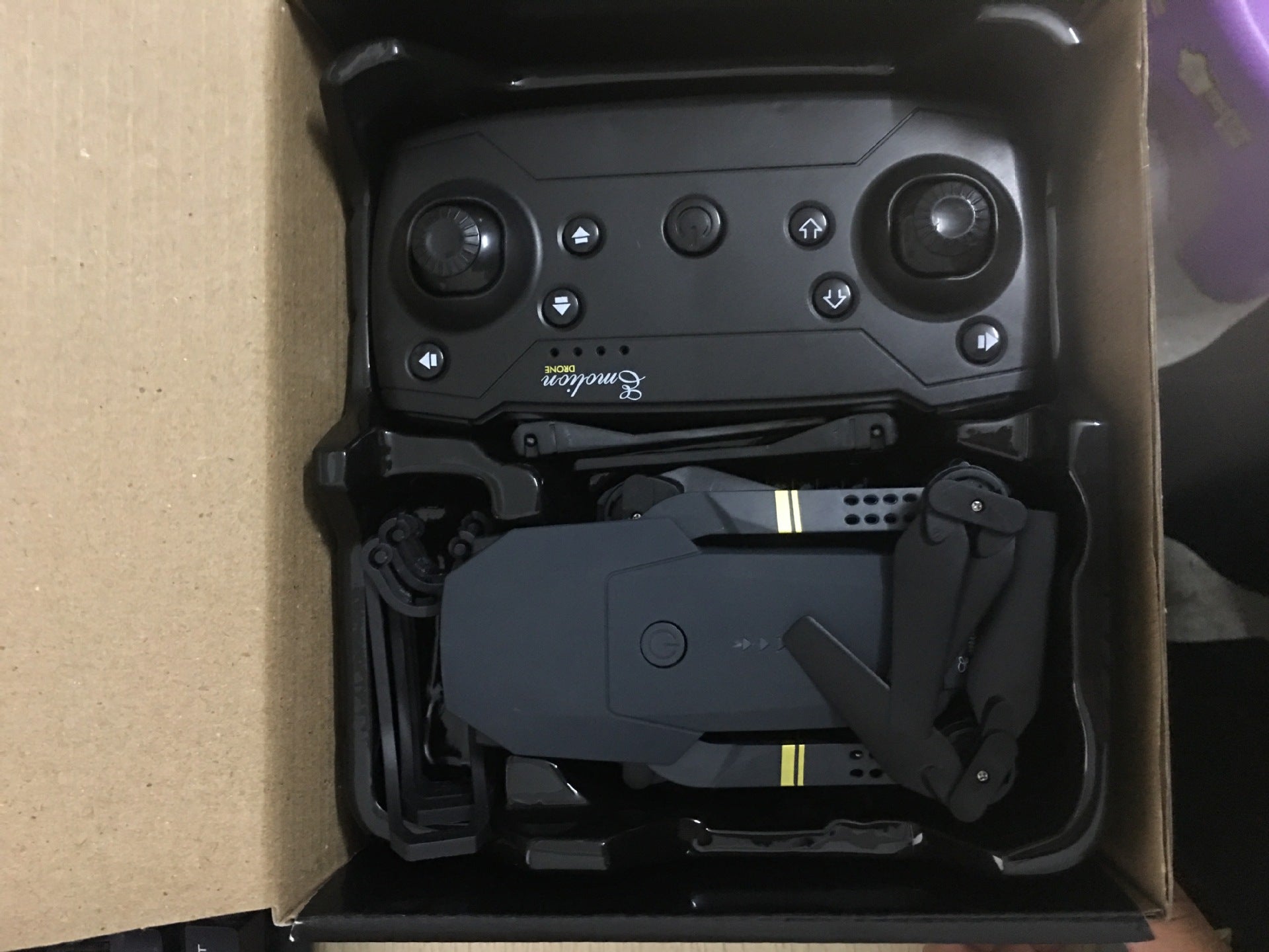 Black foldable WiFi FPV drone with carbon fiber frame, fan blades, and remote controller — view 5