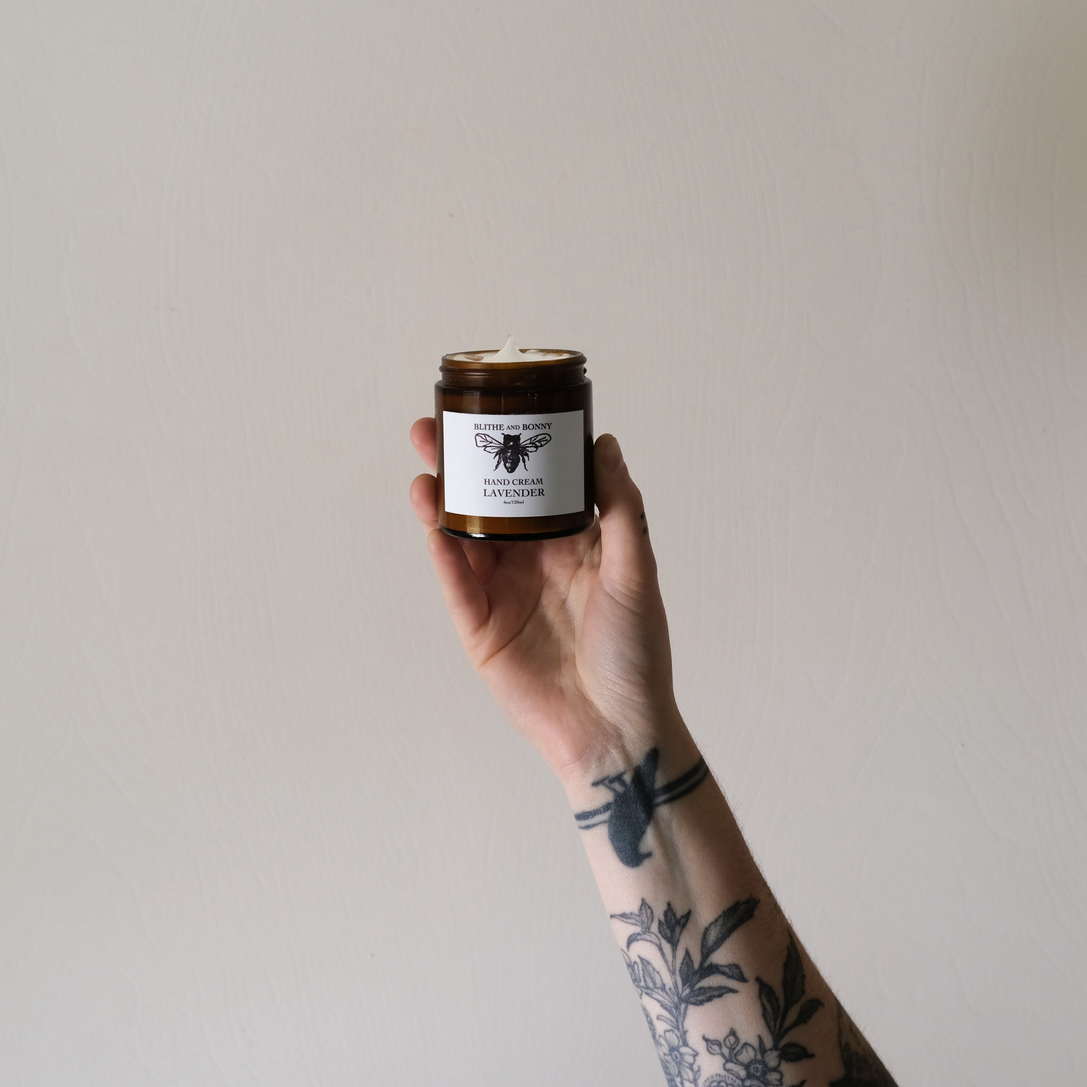 Luxurious vegan hand cream in a four ounce amber glass jar with a metal lid — view 2