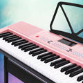 Pink Alpha 61-key electronic piano keyboard on adjustable black stand with music sheet holder