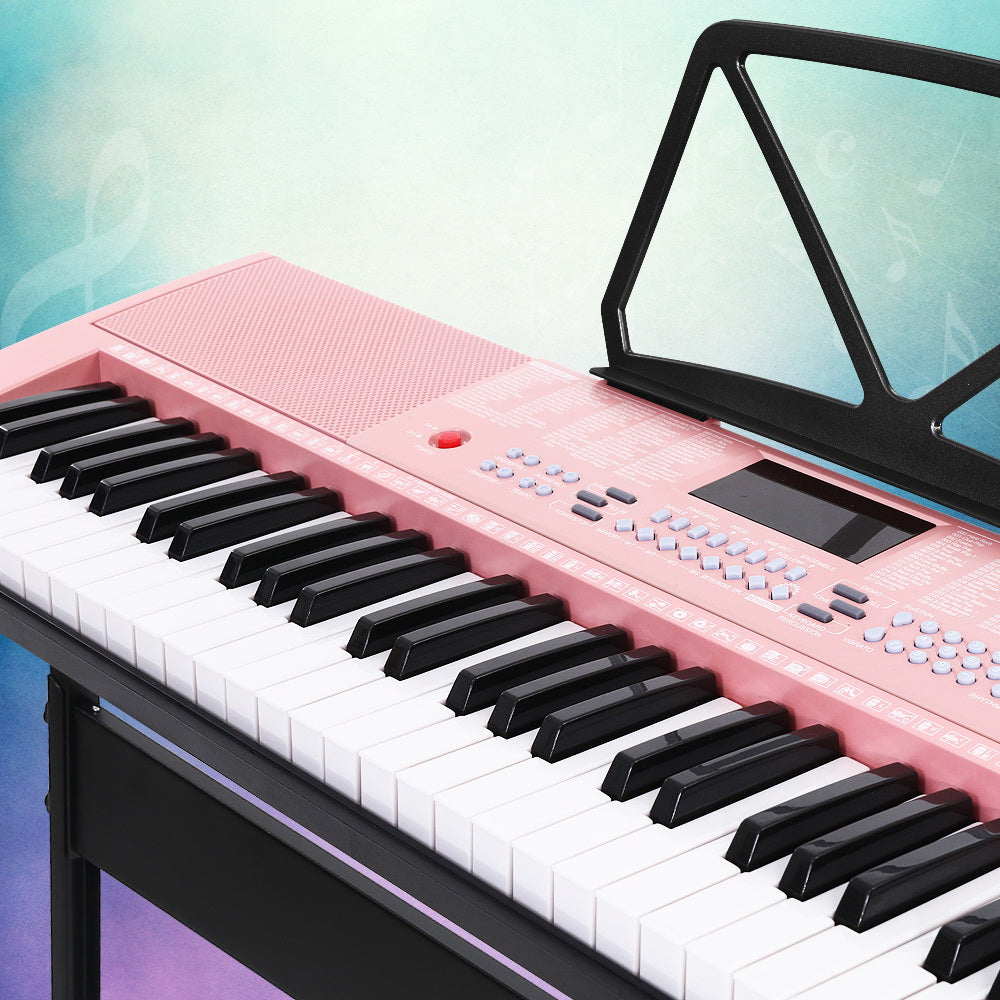 Pink Alpha 61-key electronic piano keyboard on adjustable black stand with music sheet holder