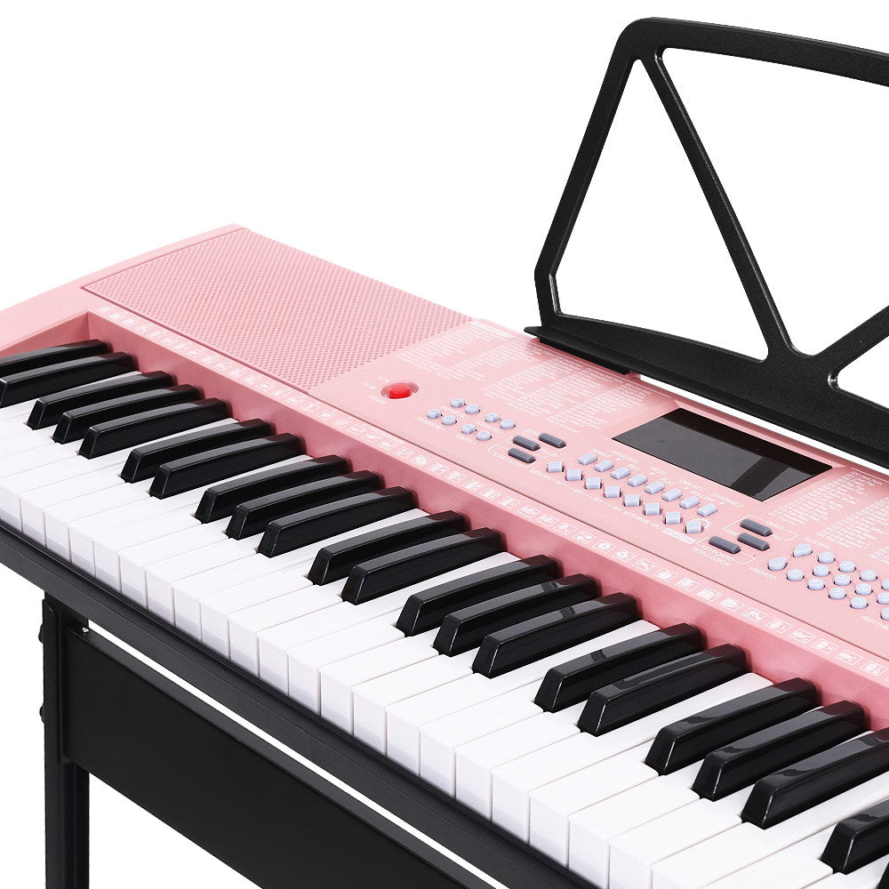 Pink Alpha 61-key electronic piano keyboard on adjustable black stand with music sheet holder — view 3