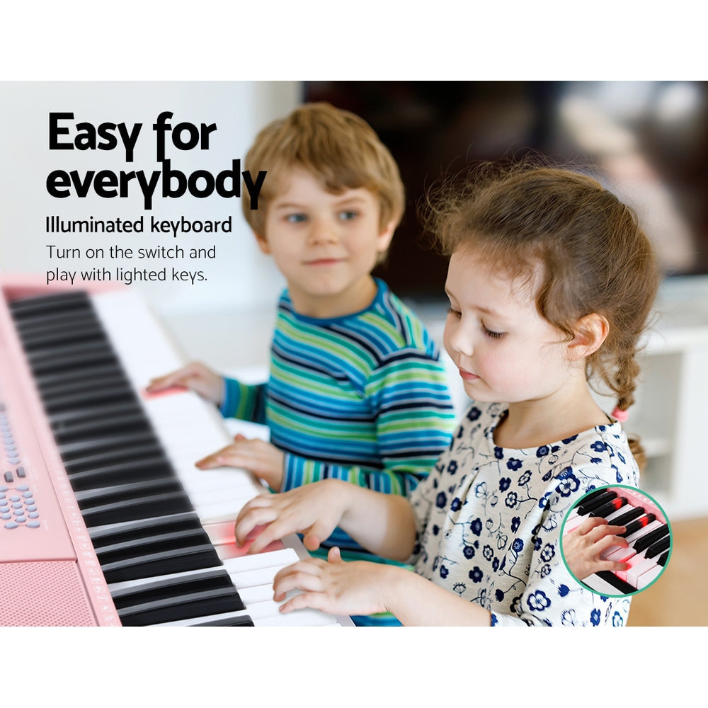 Pink Alpha 61-key electronic piano keyboard on adjustable black stand with music sheet holder — view 4