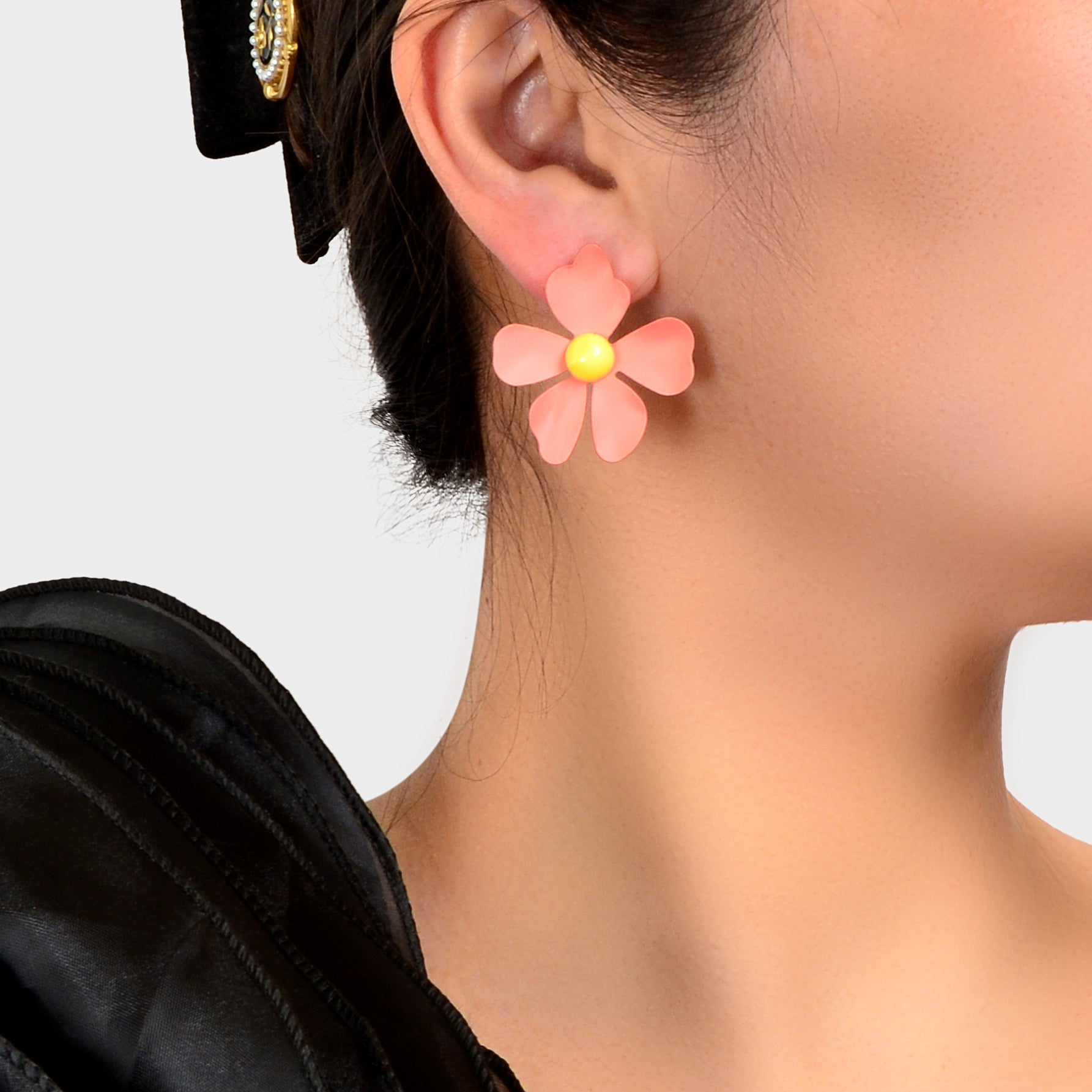 Blue and pink flower stud earrings with intricate petal details on a white background