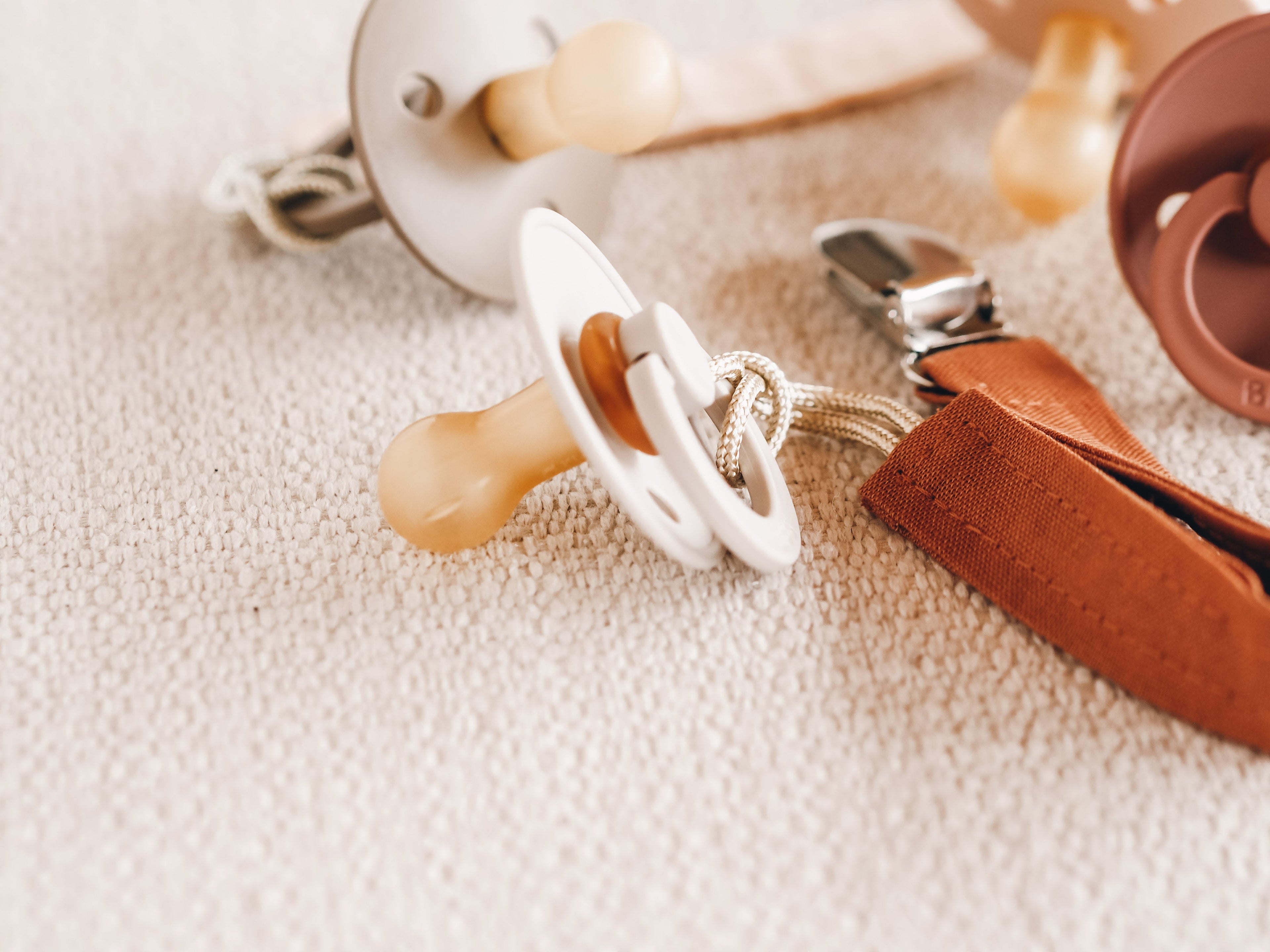Soft silicone baby pacifier with fabric holder clip in natural earth tones for infants. — view 3