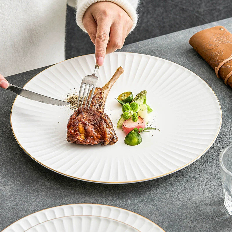 White ceramic dinner plate with pleated texture and a hand-painted gold rim — view 2