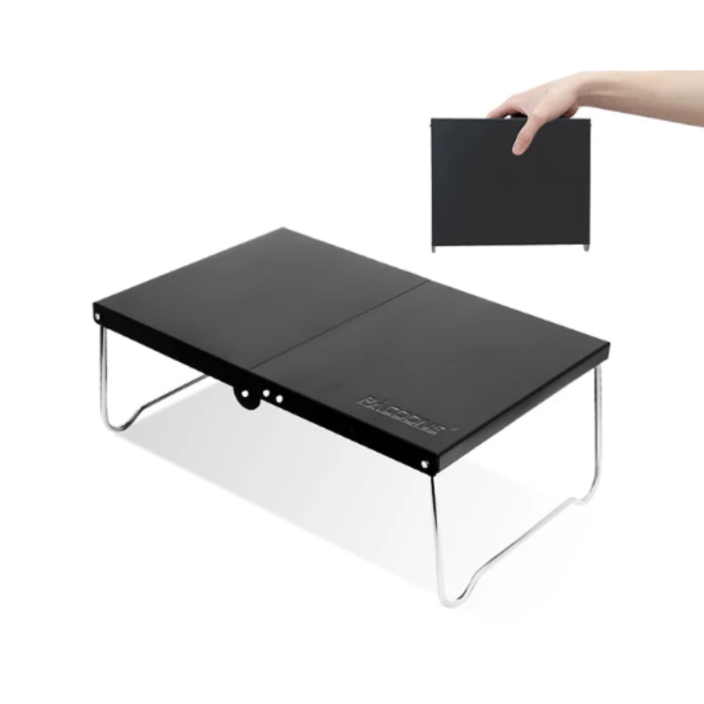 Black portable foldable camping table made of lightweight MDF, set up outdoors