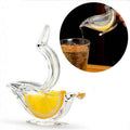 Elegant bird-shaped clear acrylic manual lemon squeezer for fresh citrus juice preparation.