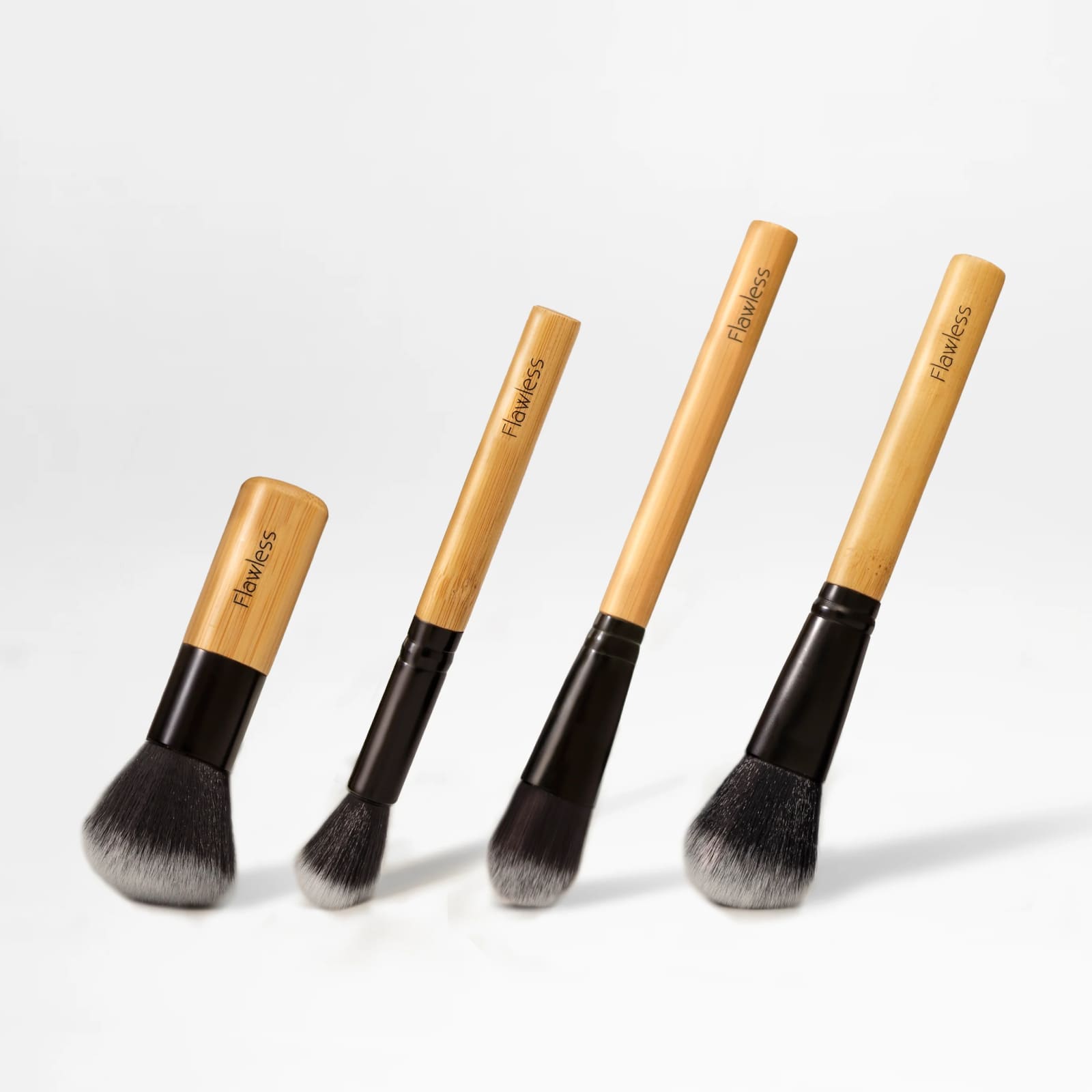 Essential makeup brush set featuring four bamboo handle brushes and an organic cotton drawstring bag