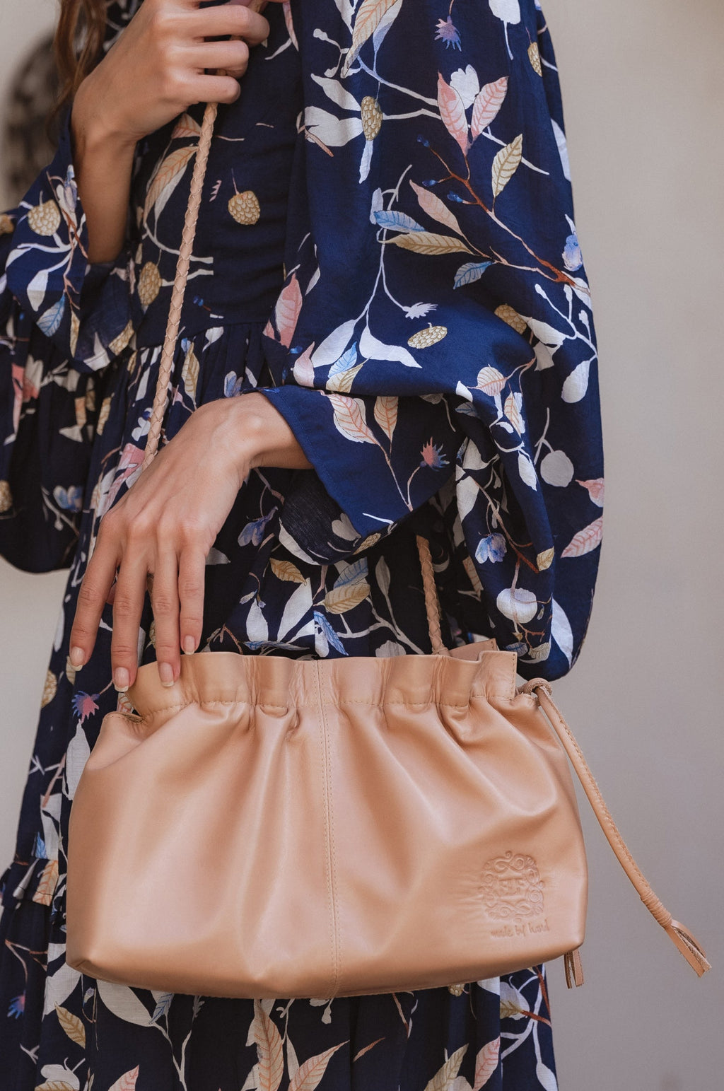 Beige genuine leather Etoile crossbody clutch bag with braided strap and drawstring closure