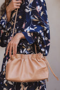 Beige genuine leather Etoile crossbody clutch bag with braided strap and drawstring closure