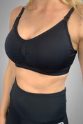 Black seamfree maternity and nursing bra with ribbed underband and drop-down nursing clips