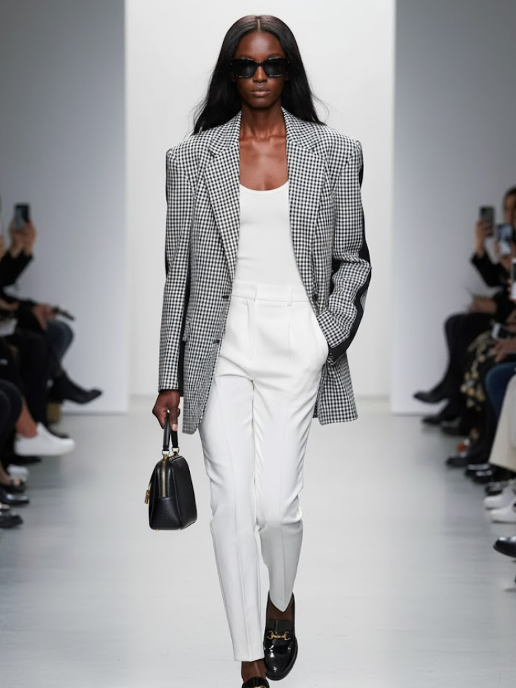 Women's oversized black and white houndstooth blazer with structured shoulders and contrasting sleeve band