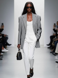 Women's oversized black and white houndstooth blazer with structured shoulders and contrasting sleeve band