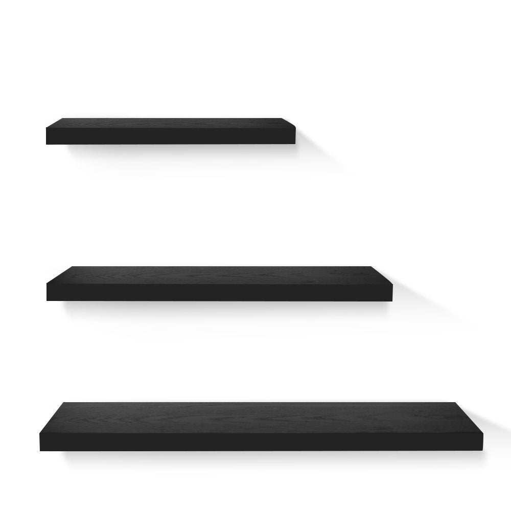 Three modern minimalist black floating wall shelves arranged on a wall for stylish home decor