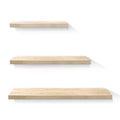 Oak floating wall shelves set of three mounted in a modern living room display