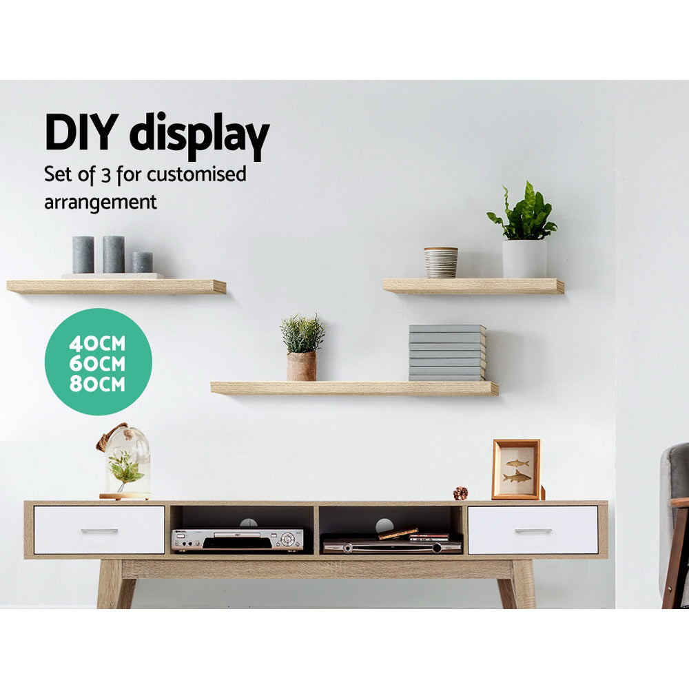 Oak floating wall shelves set of three mounted in a modern living room display — view 3