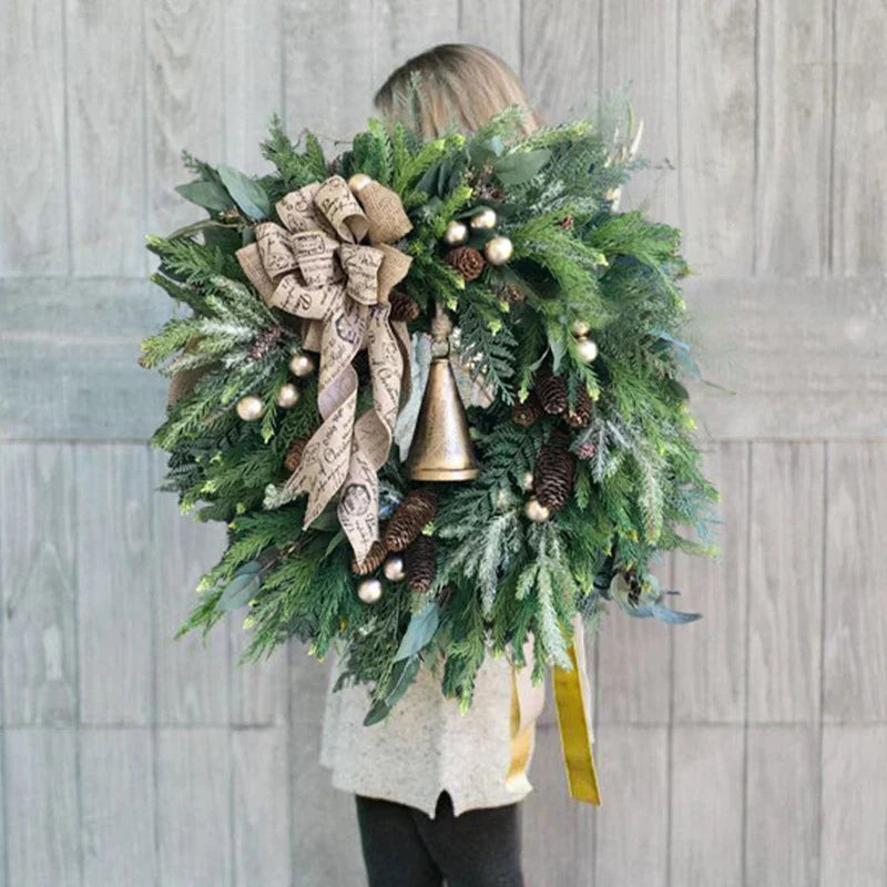 Farmhouse Christmas wreath with green pine foliage, red berries, and oversized golden bells — view 2