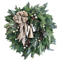 Farmhouse Christmas wreath with green pine foliage, red berries, and oversized golden bells