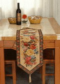 Colorful woven floral table runner with rustic country design on a wooden dining table surface